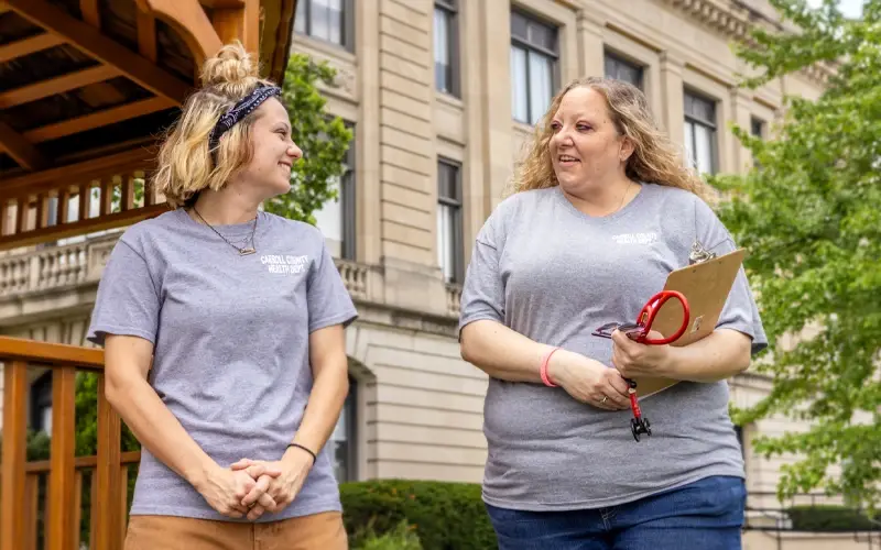 Two people meeting outside of a building.